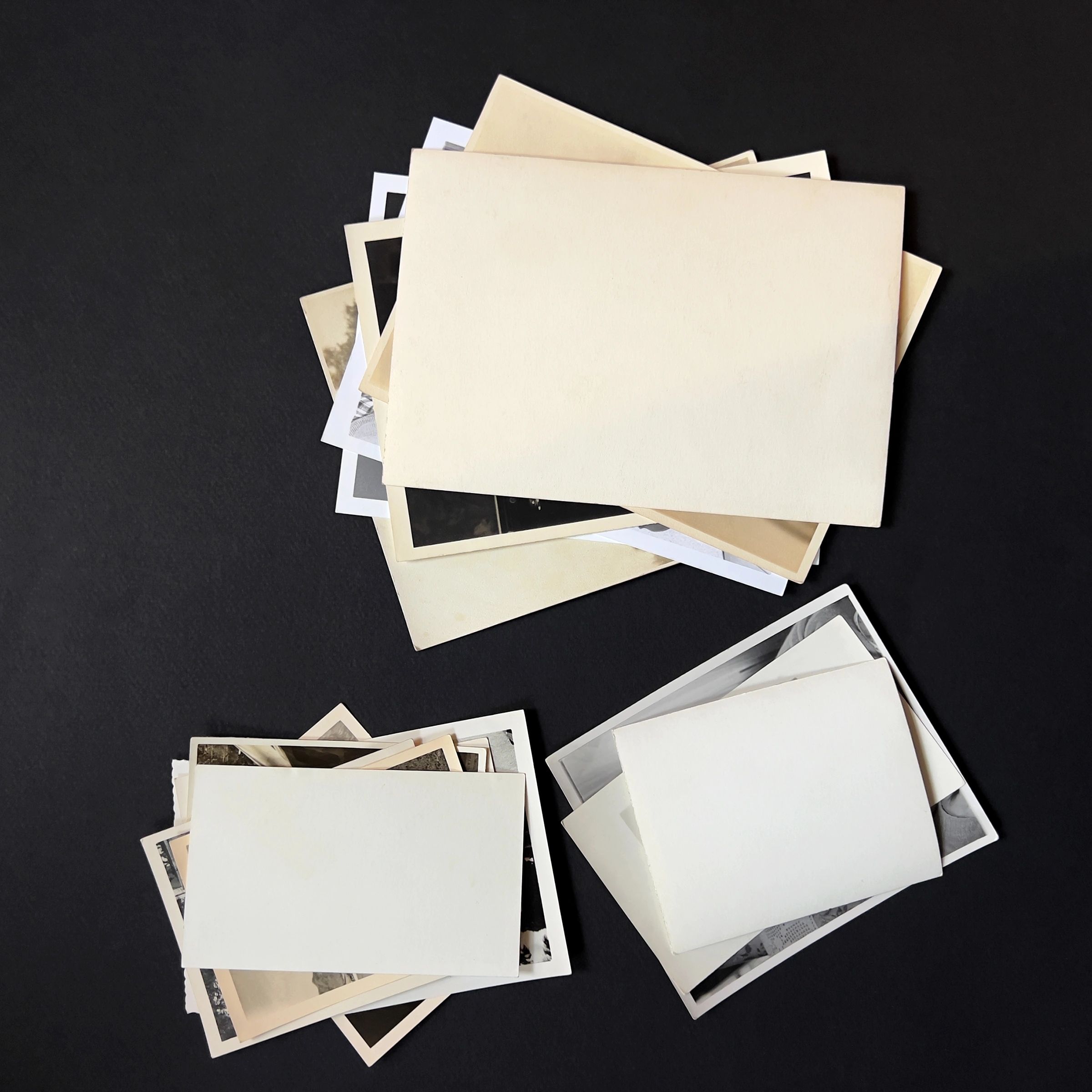 Stacks of old photographs representing archived family images